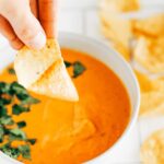 Vegan queso dip made with cashews and roasted tomatoes