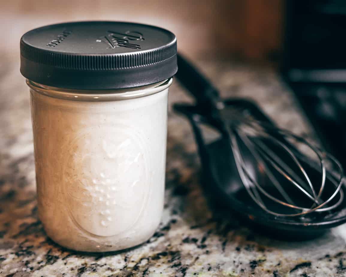 Homemade coconut milk creamer stored in a wide-mouth mason jar and air-tight lid
