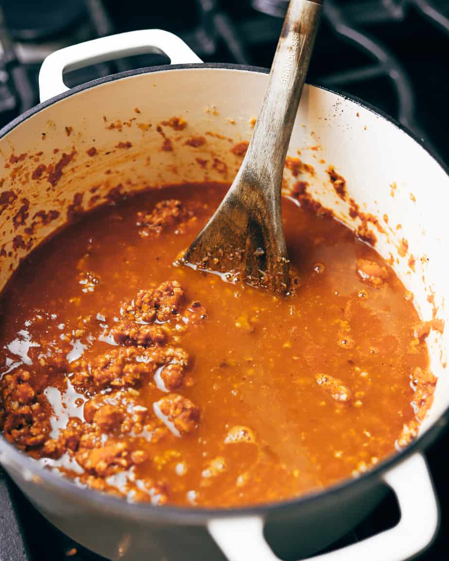 simmering white wine into a slow cooked meat sauce to make bolognese