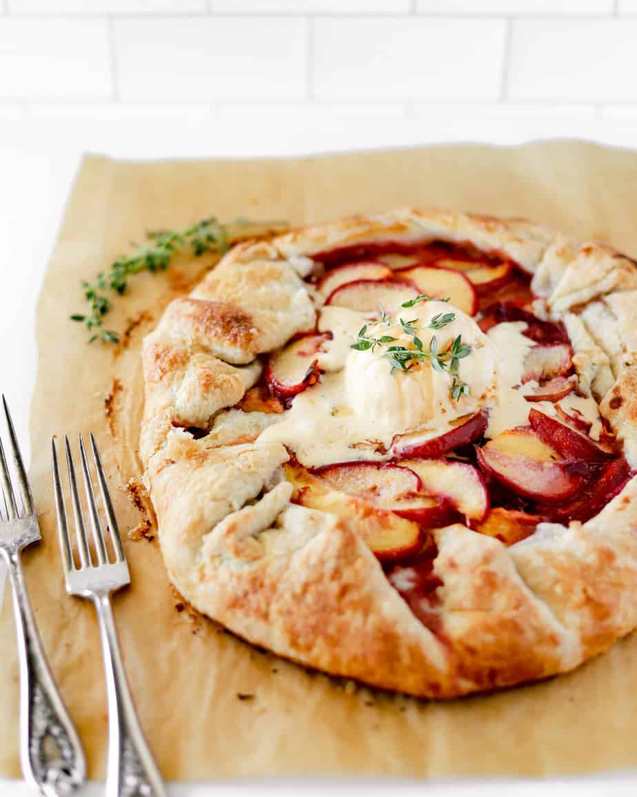 Peach galette topped with a scoop of salted vanilla gelato that's beginning to melt into the peaches