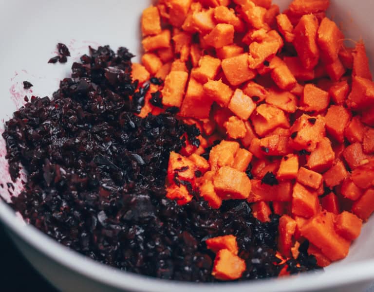 mixing bowl with diced sweet potatoes and shredded beets
