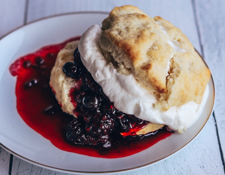 berries and cream over a cream biscuit