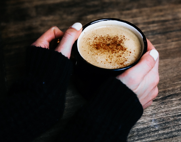bulletproof coffee made with butter and MCT oil is frothy and topped with cinnamon