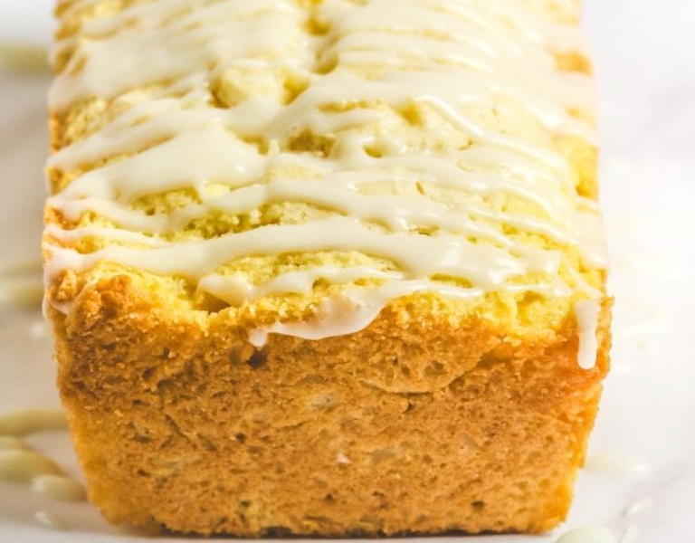 loaf of lemon cake drizzled with yellow icing